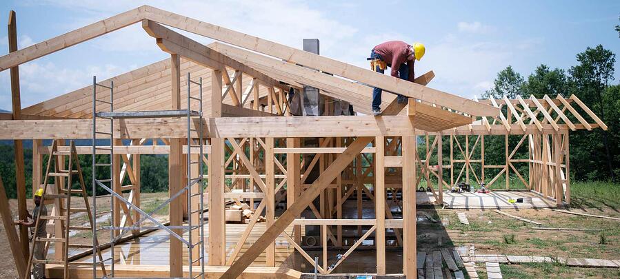 Image Of A Home Builder Sitting Atop Of A Wooden-Framed House With Tools In His Built And, Frankly, If Home-Building Like This Was Happening A Million More Times Per Year In The United States We'D Have Lower Home Prices And Greater Access To Homeownership For Underserved Households And Everyone Else