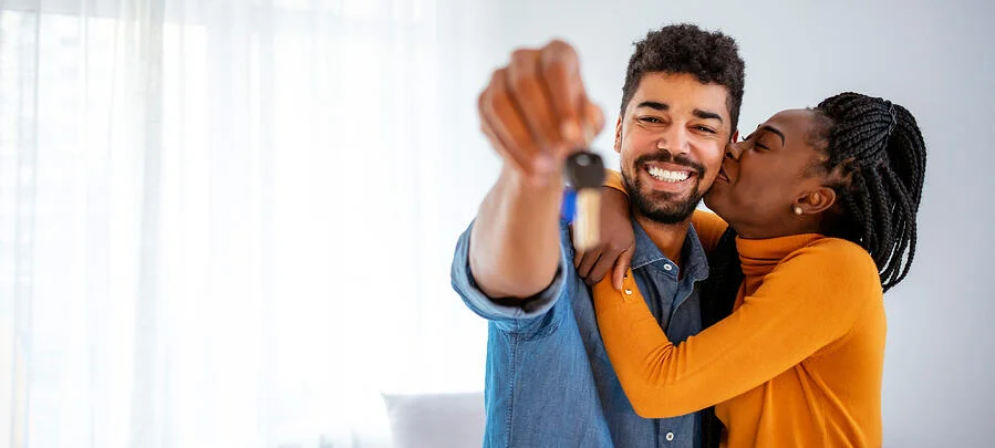 This is one of those instances where stock photography falls short because the image is supposed to show happy first-time home buyers with the keys to their new home but they're actually holding up a car key so it's kind of weird