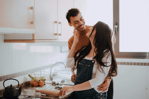 First-time home buyers cooking in their new kitchen or maybe just posing for a photo with a bowl of fake fruit