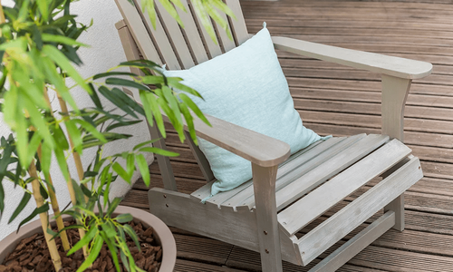This is an outdoor chair that's probably on the newer side because the pillow hasn't started to collect that weird moldy stuff that many outdoor pillows start to show